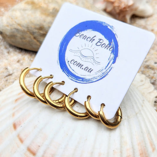 Set of gold hoop earrings on a 'Beach Boho' branded card with seashells in the background.