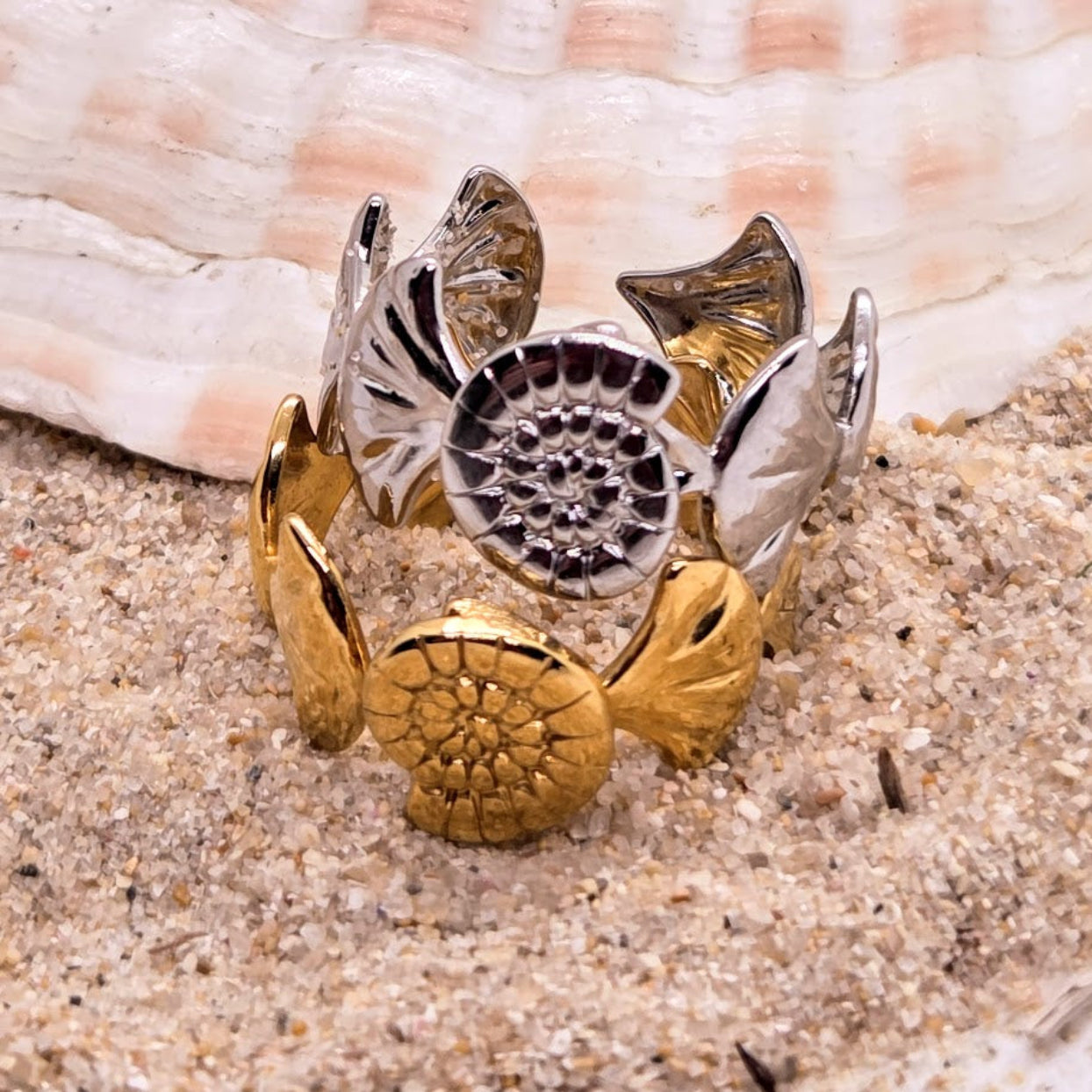 Decorative ring with floral designs on a sandy background