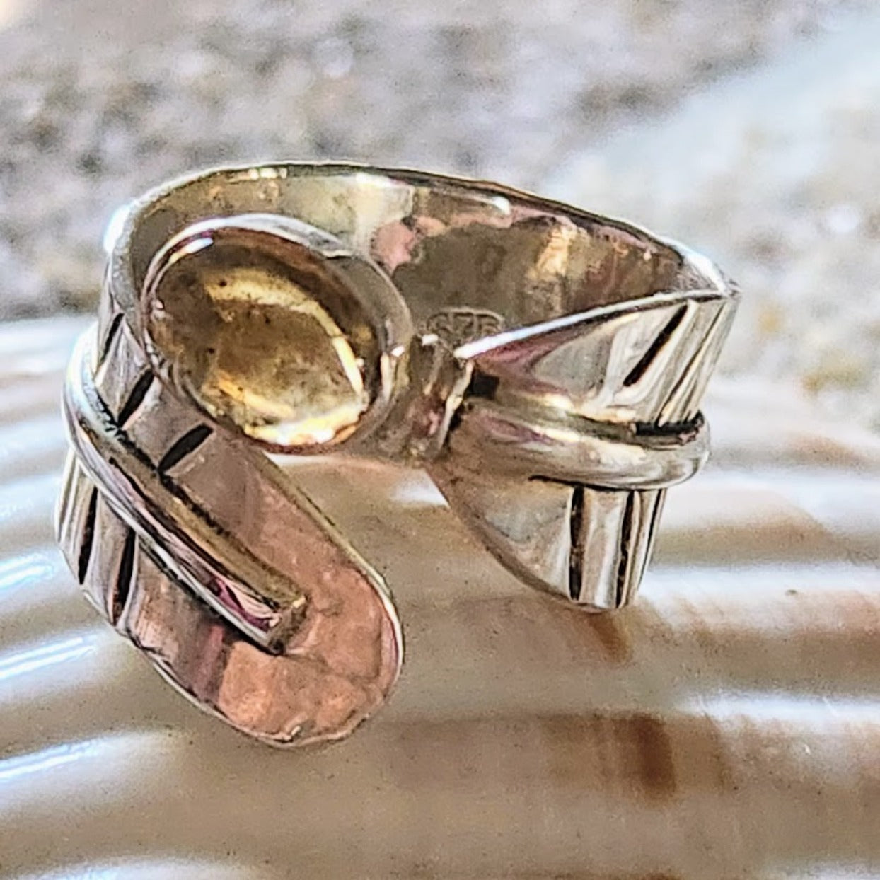 Gold and silver ring on a textured surface