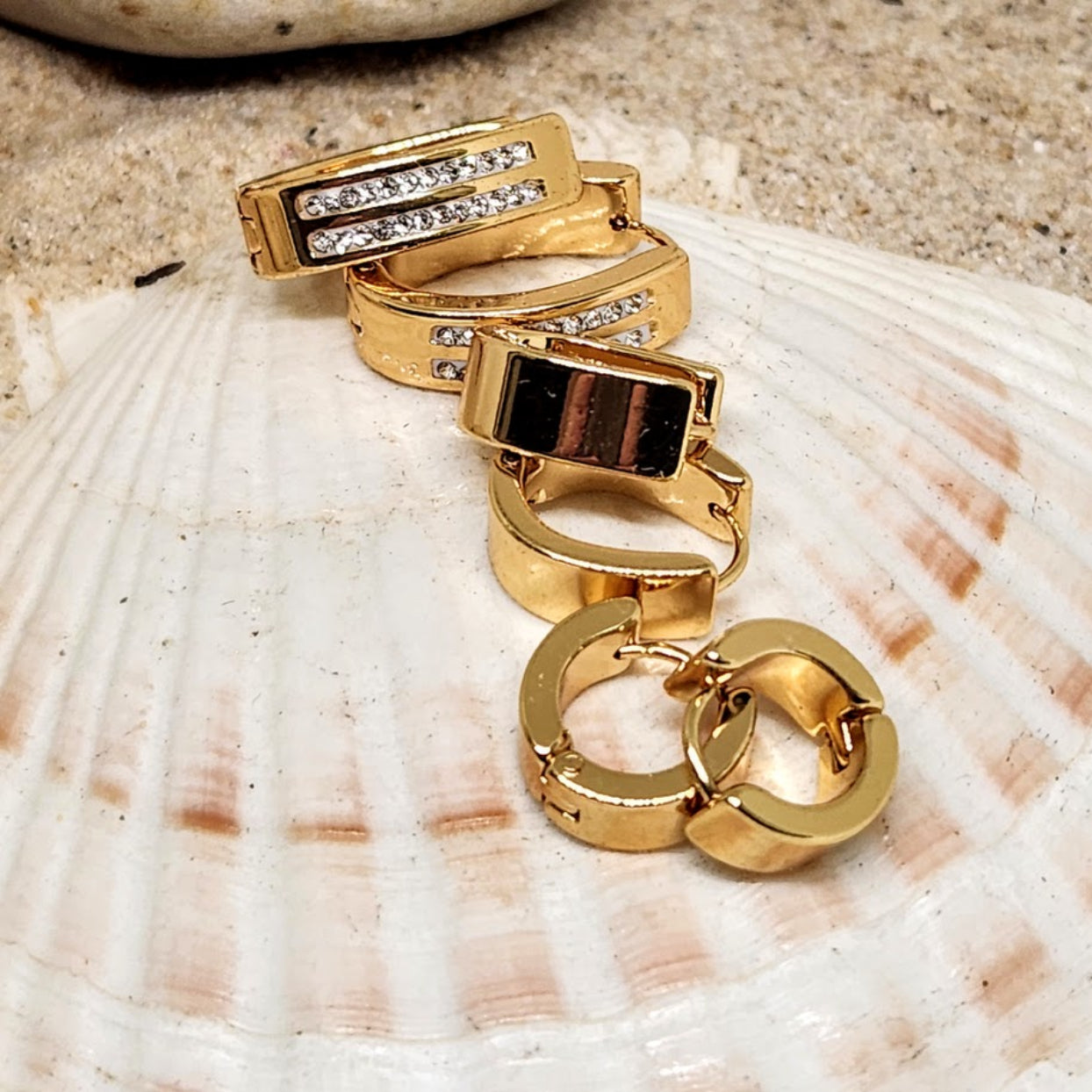 Gold rings with gemstones on a seashell