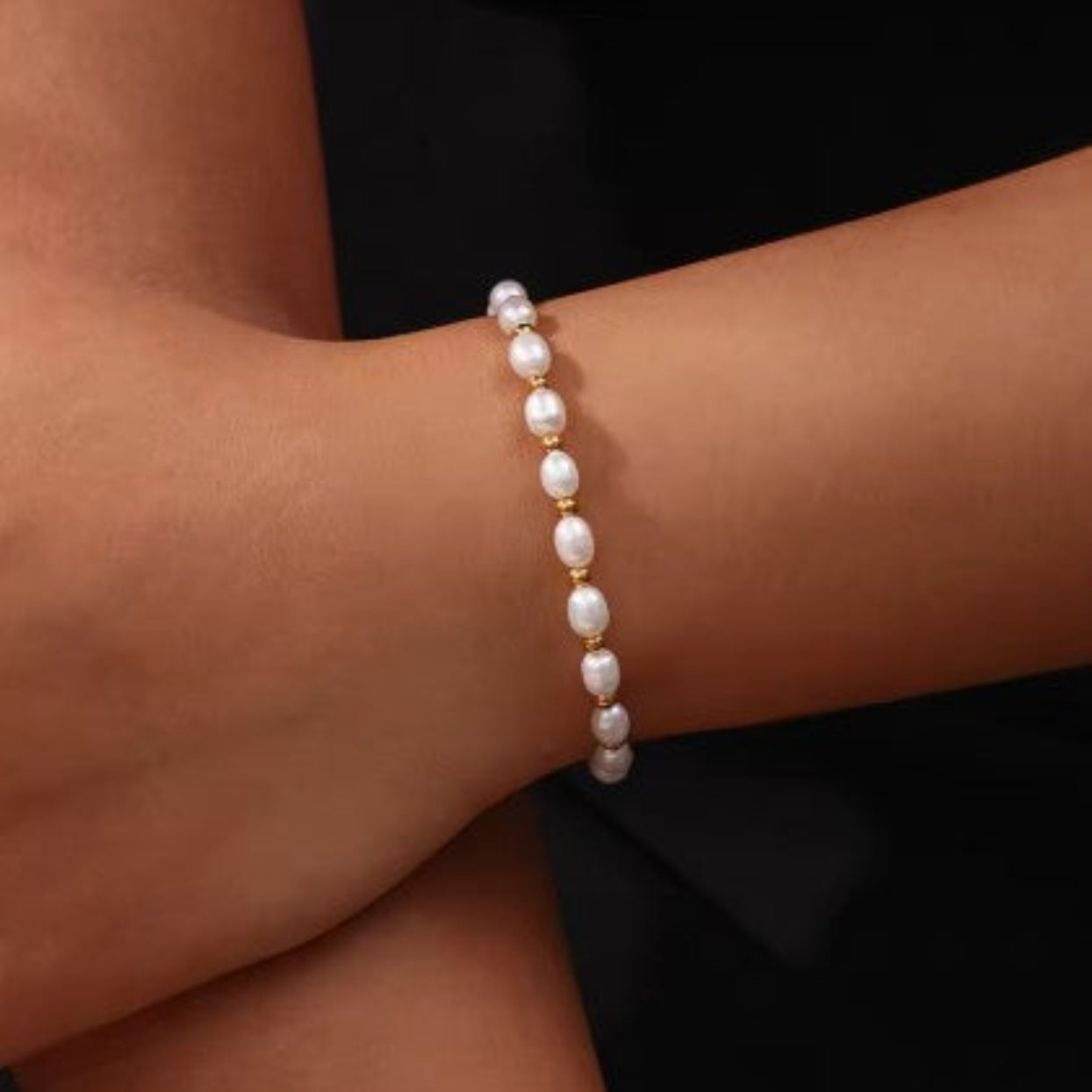 Pearl bracelet on a wrist with a blurred background