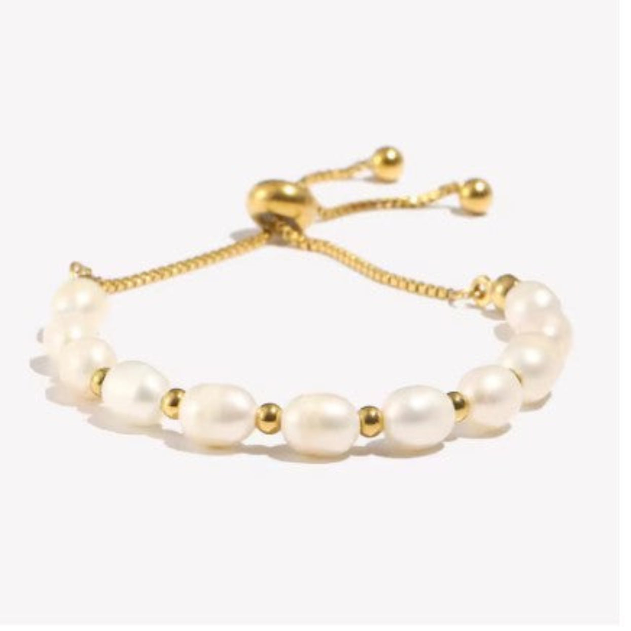 Pearl bracelet with gold accents on a white background