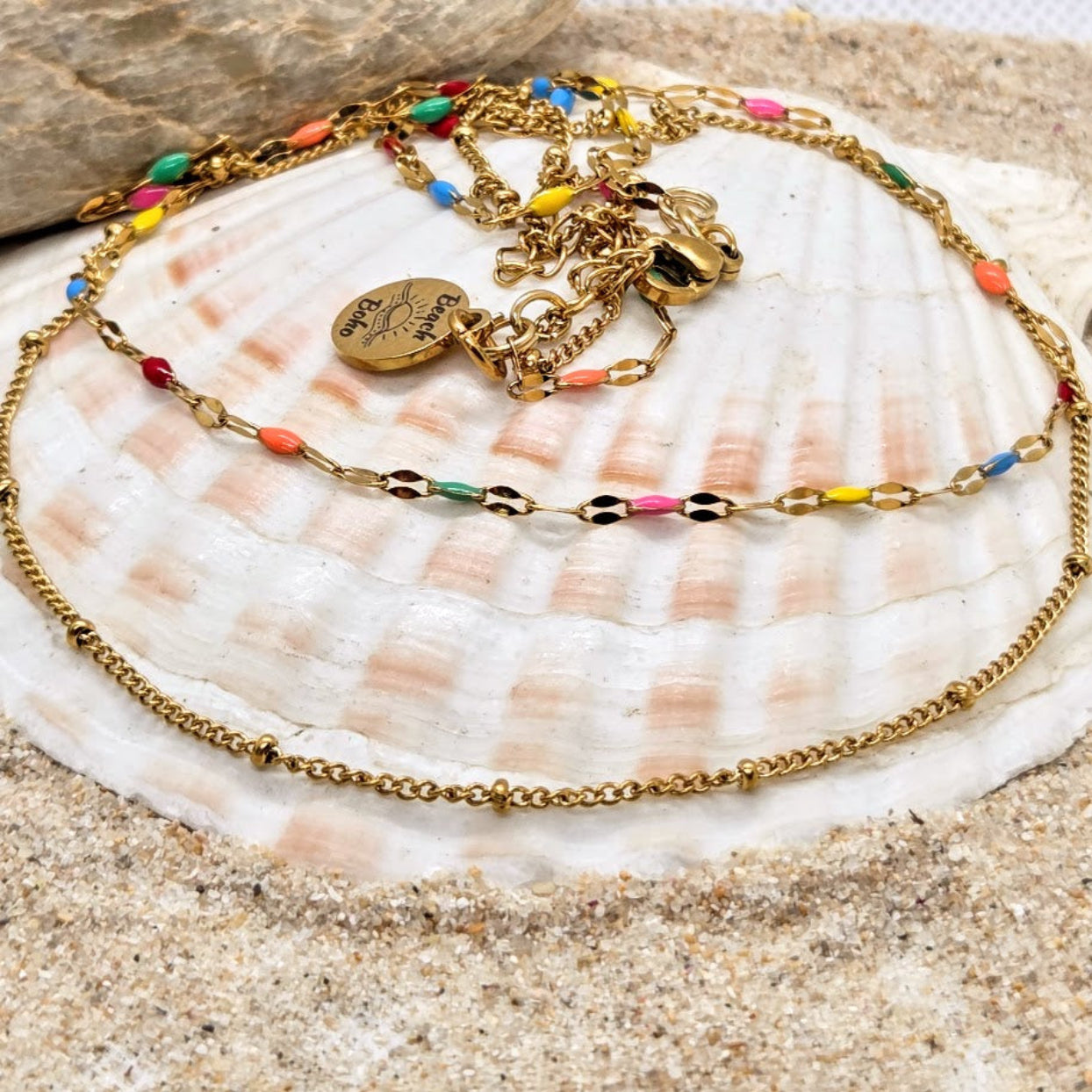 Gold bracelet with colorful beads on a seashell