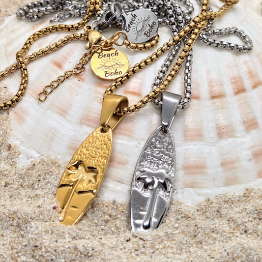 Gold and silver necklaces with pendants on a seashell background