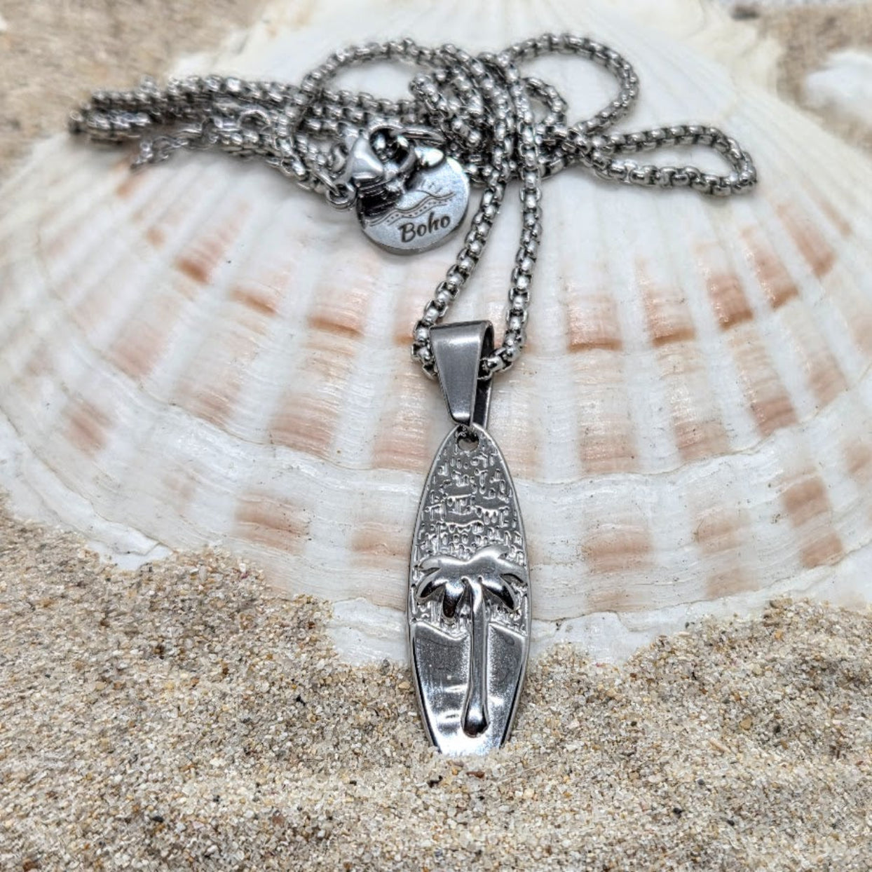 Silver necklace with pendant on a seashell