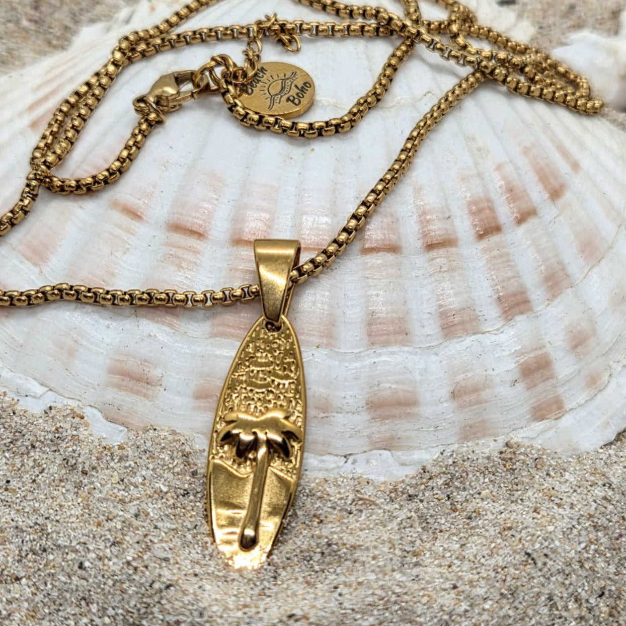 Gold necklace with a pendant on a seashell