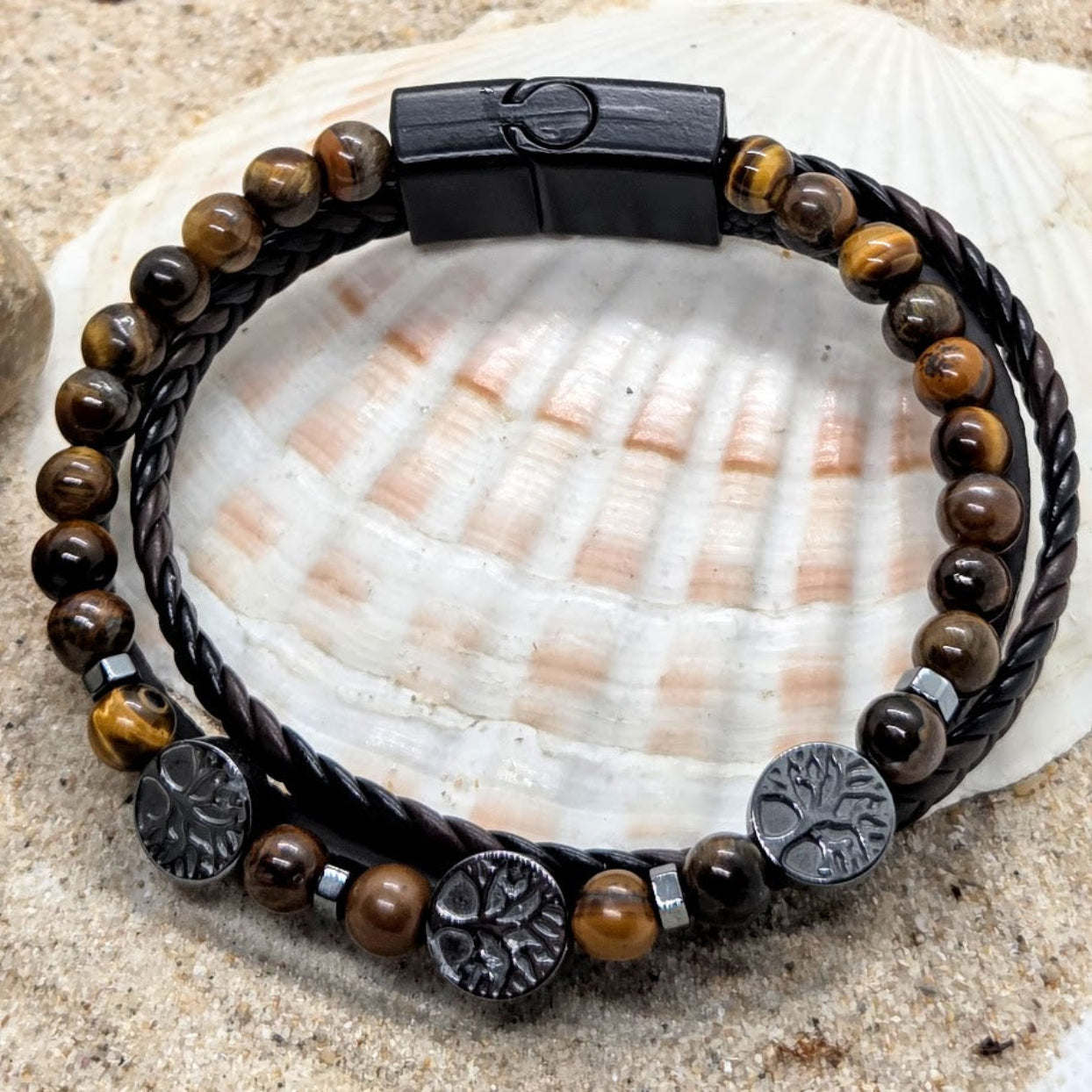 Bracelet with brown beads and black metal elements on a seashell