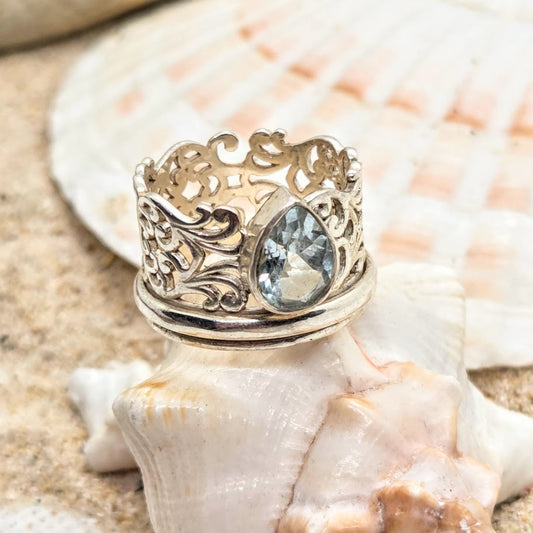 Decorative ring with a blue gemstone on a seashell