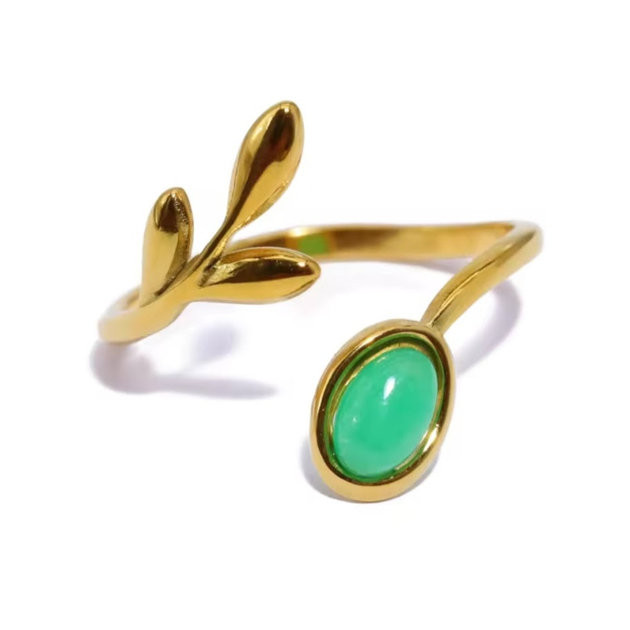 Gold ring with a green gemstone on a white background