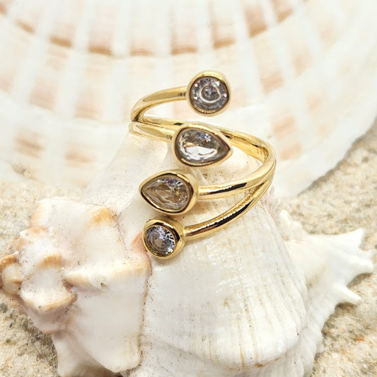 Gold ring with diamond-like stones on a seashell