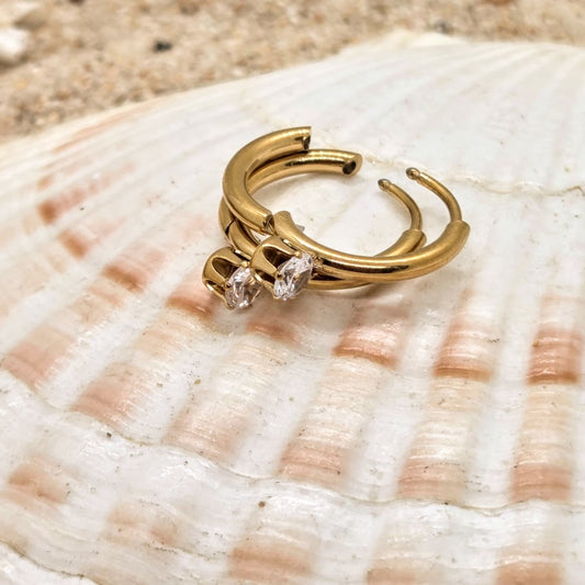 Gold hoop earring with a diamond on a seashell