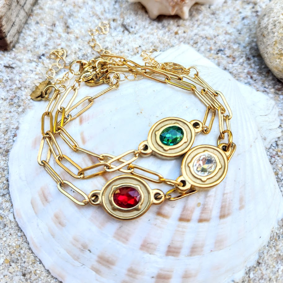 Gold bracelet with gemstones on a shell