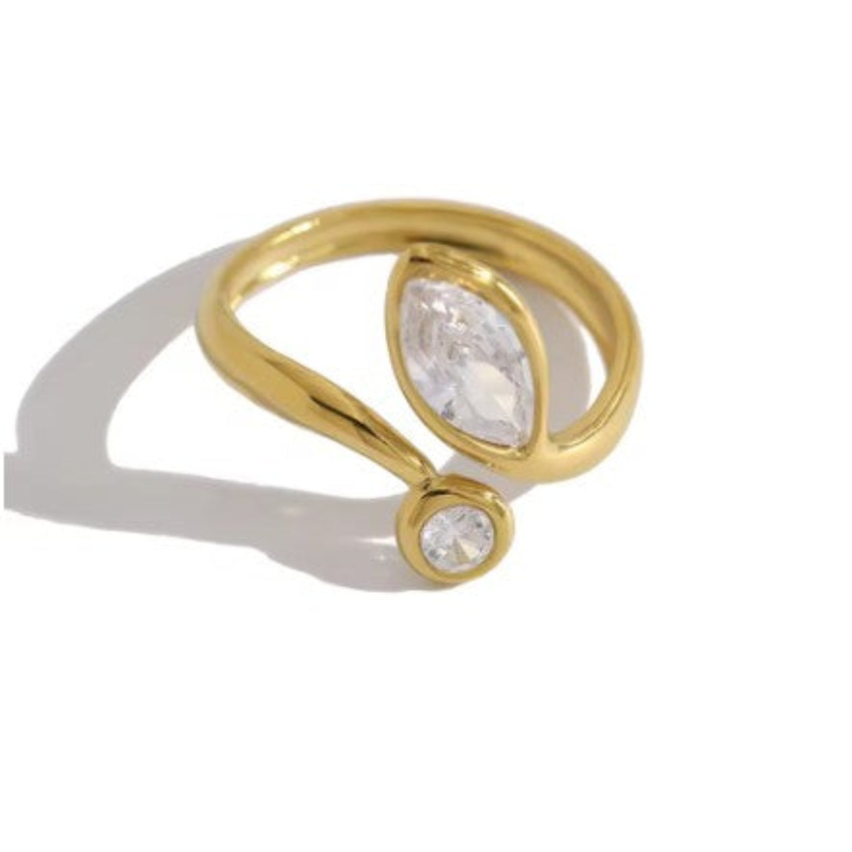 Gold ring with two clear gemstones on a white background