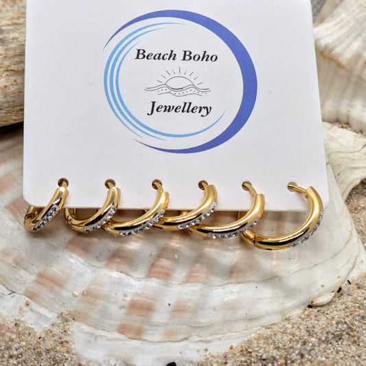 Set of gold hoop earrings on a 'Beach Boho Jewellery' card with seashells in the background.
