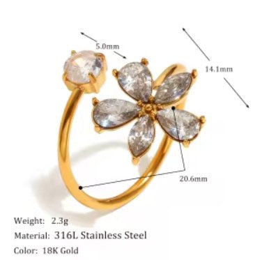 Gold ring with clear stones and measurements on a white background