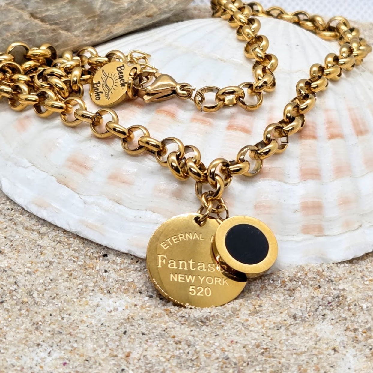 Gold chain bracelet with a tag on a seashell