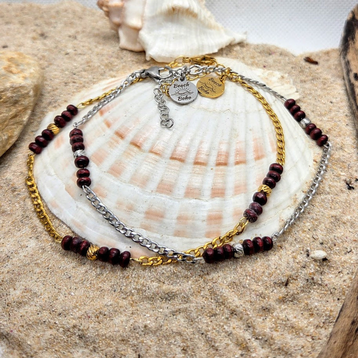 Necklace with red beads and gold chain on a seashell
