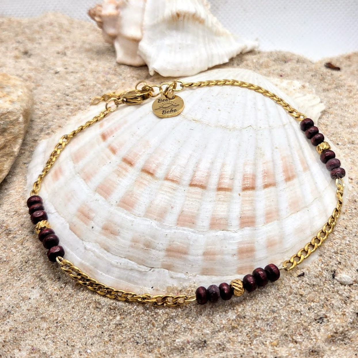 Gold bracelet with purple beads on a seashell