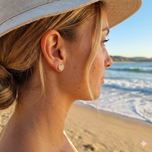 Woman wearing a heart-shaped earring on a beach