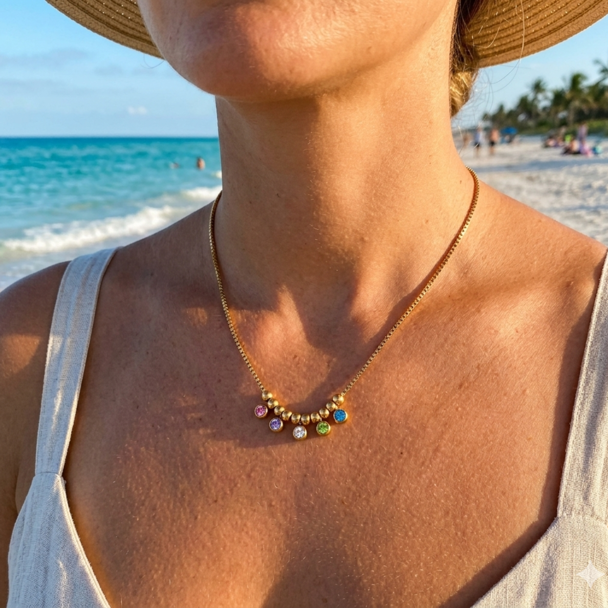 Person wearing a colorful beaded necklace with a beach in the background