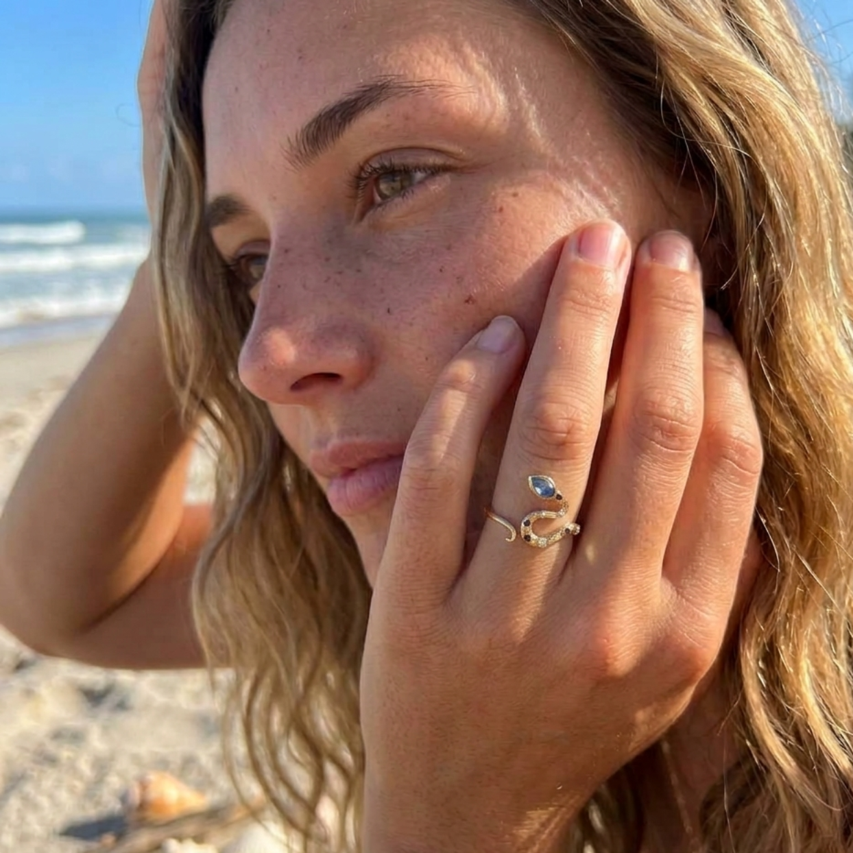 Woman on a beach with a ring on her finger