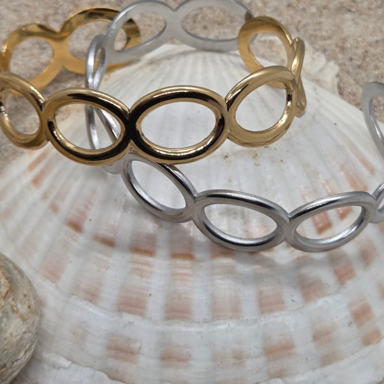 Gold and silver bracelet on a seashell