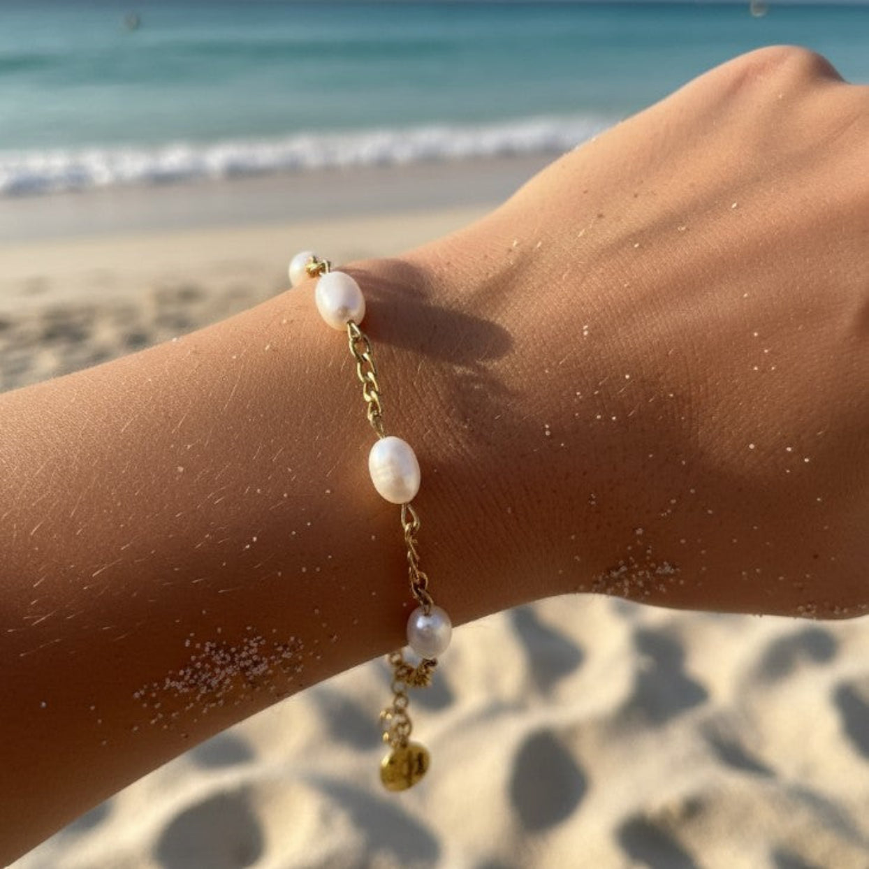 Pearl bracelet on a wrist with a beach background
