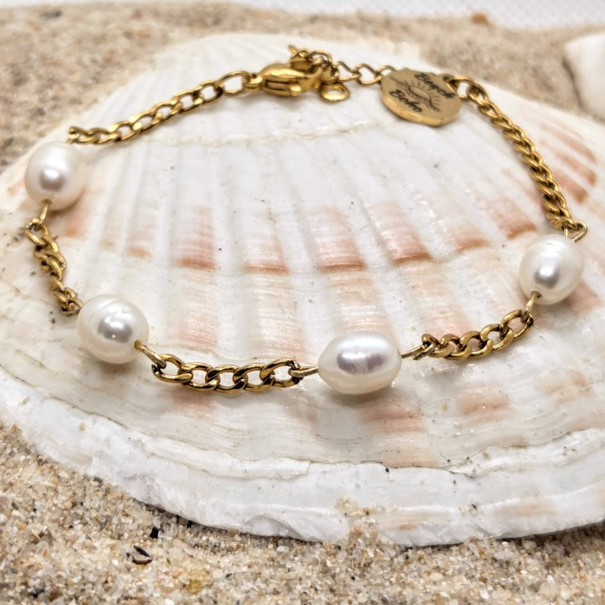 Gold bracelet with pearls on a seashell