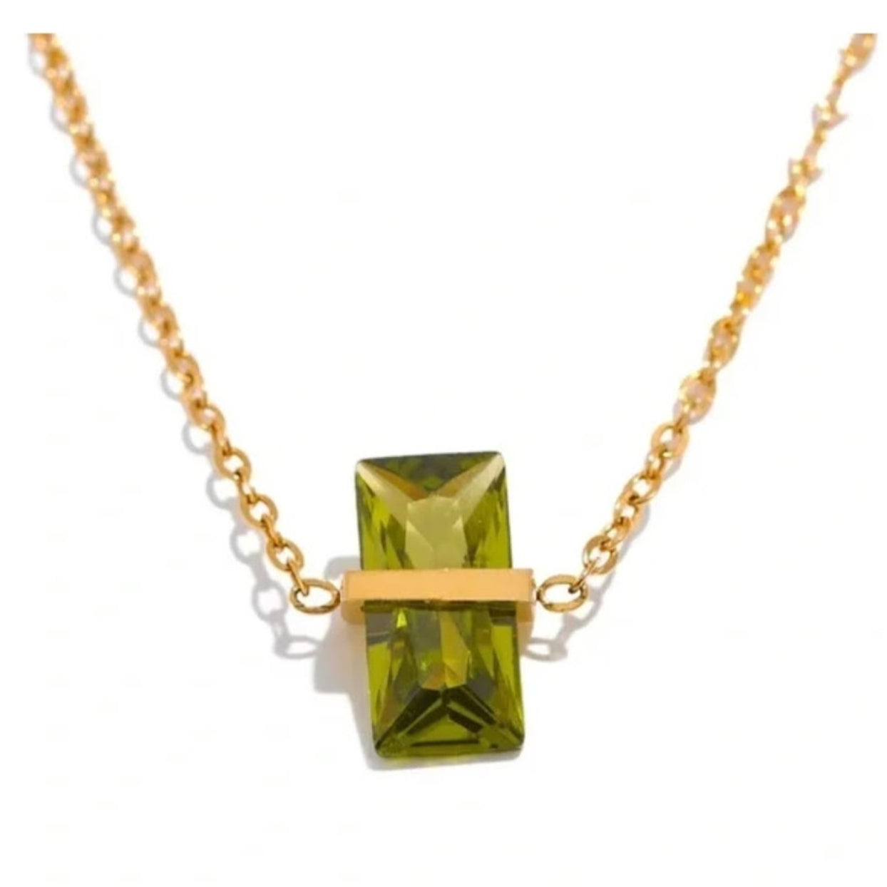 Gold necklace with a green gemstone pendant on a white background