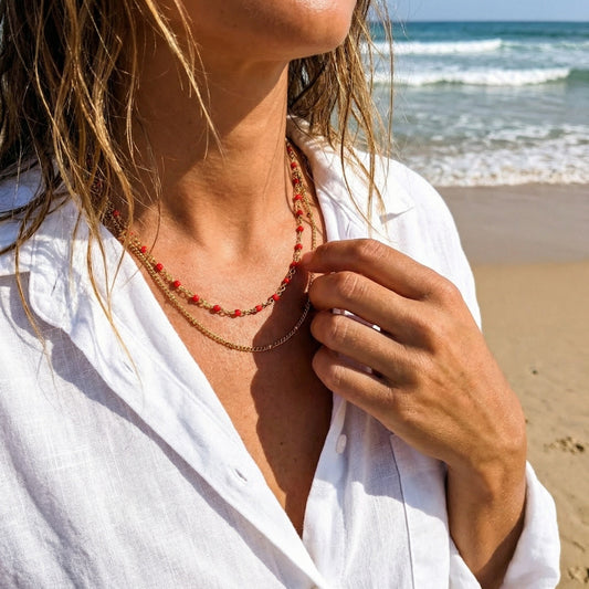 Person wearing a necklace on a beach