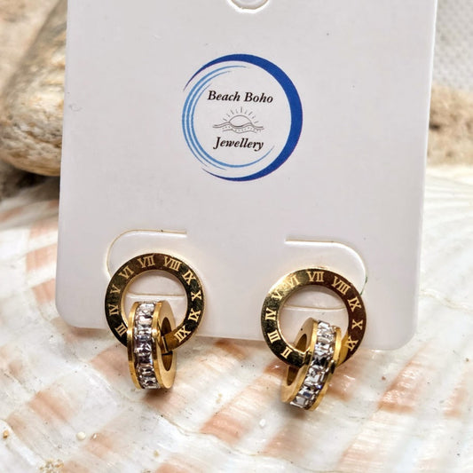 Gold hoop earrings with Roman numeral design on a 'Beach Boho Jewellery' card.