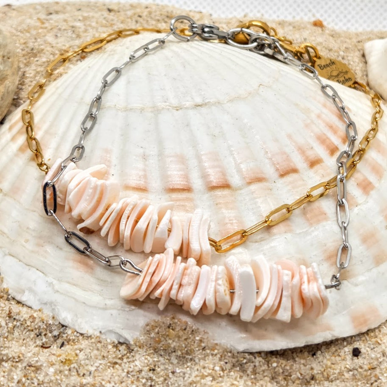 Necklace with shell pendants on a seashell with sand background