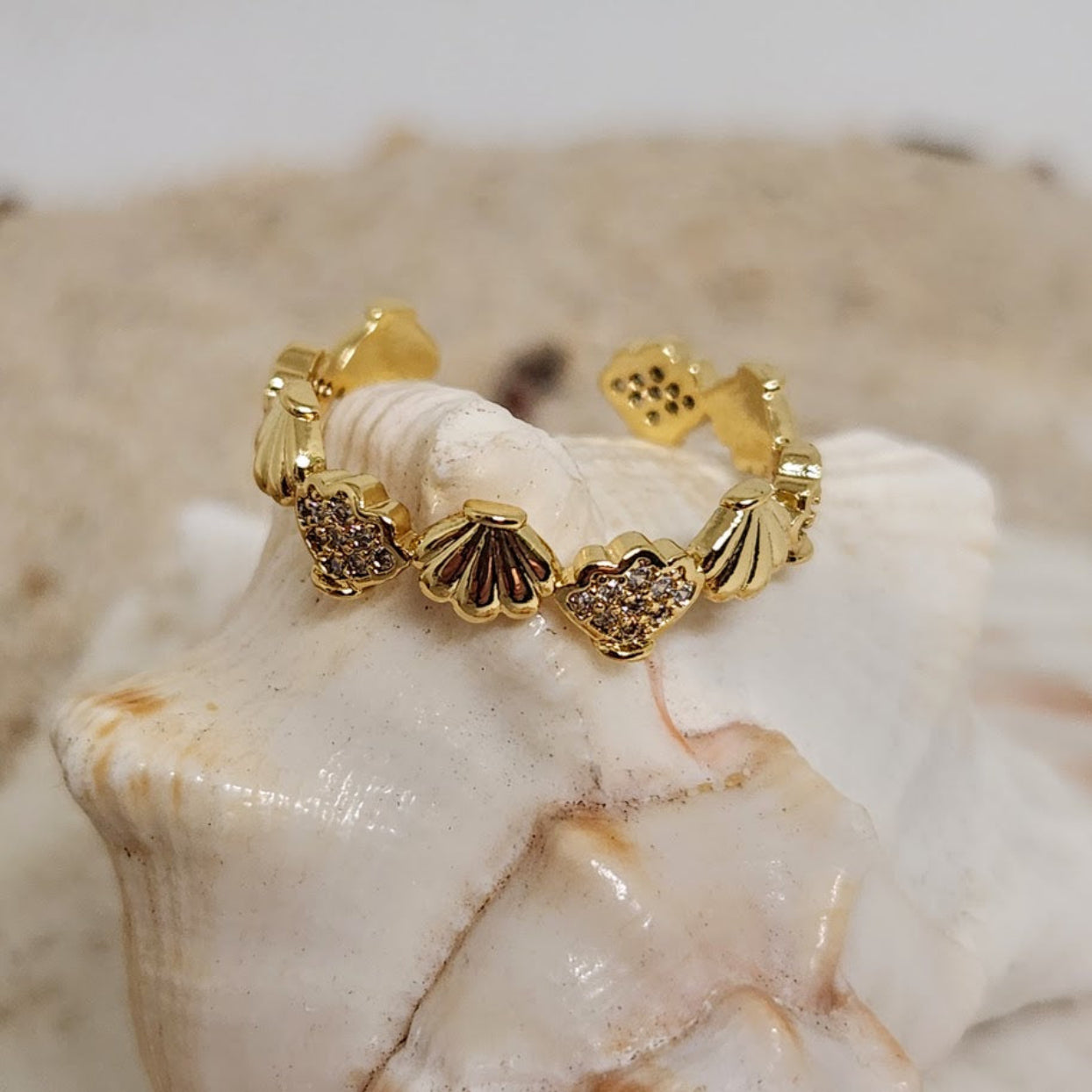 Gold bracelet with shell designs on a seashell