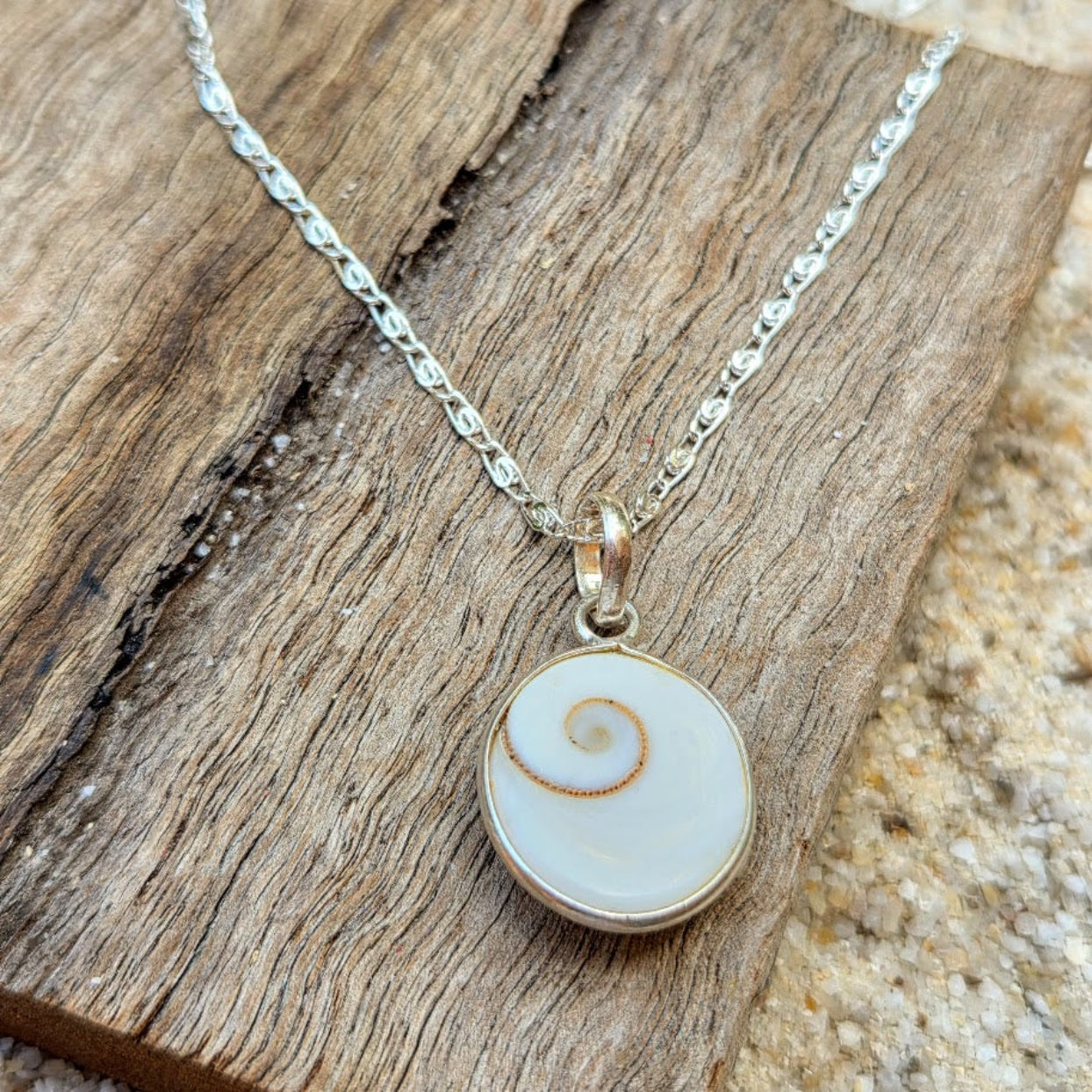 Necklace with a round pendant on a wooden surface
