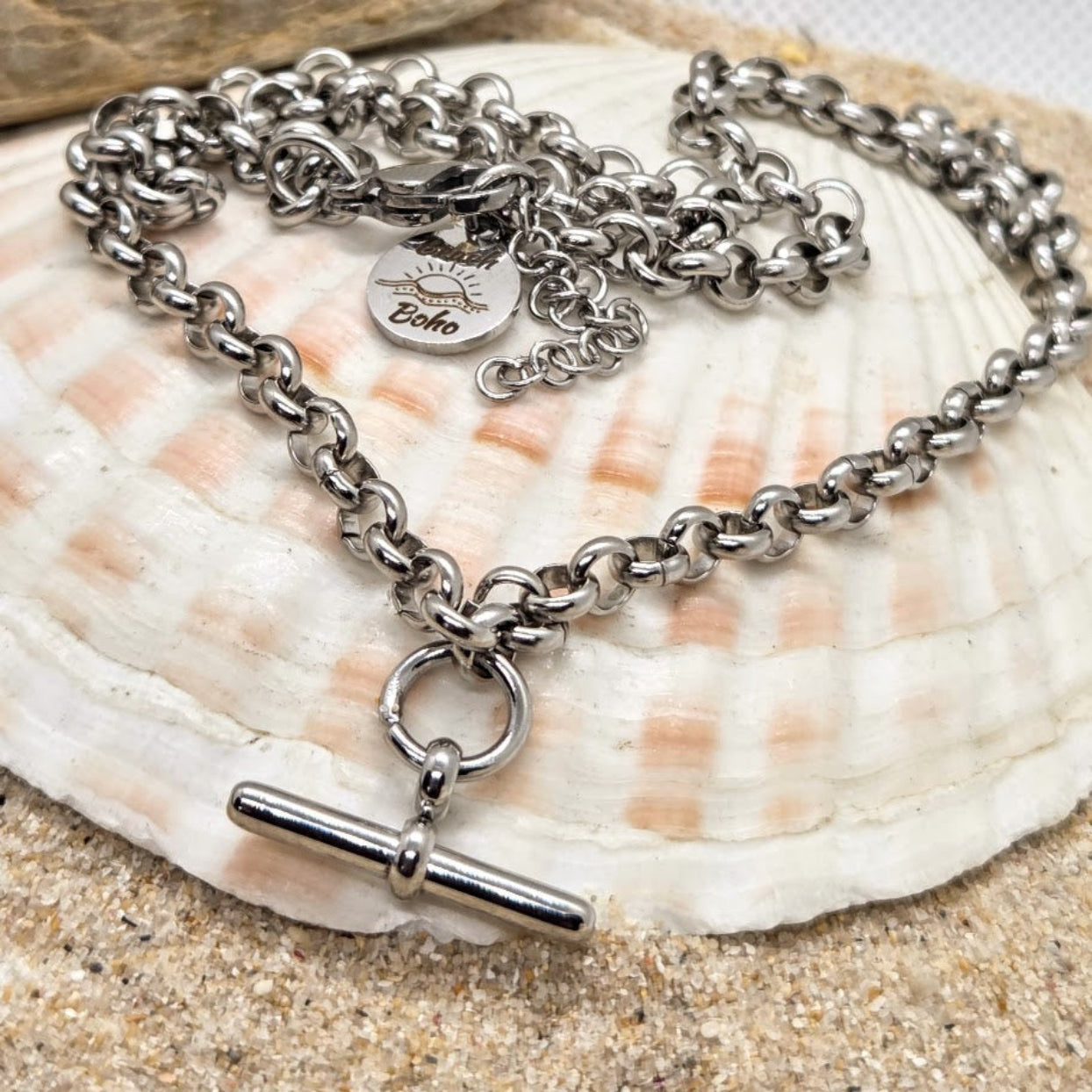 Silver chain necklace with a pendant on a seashell