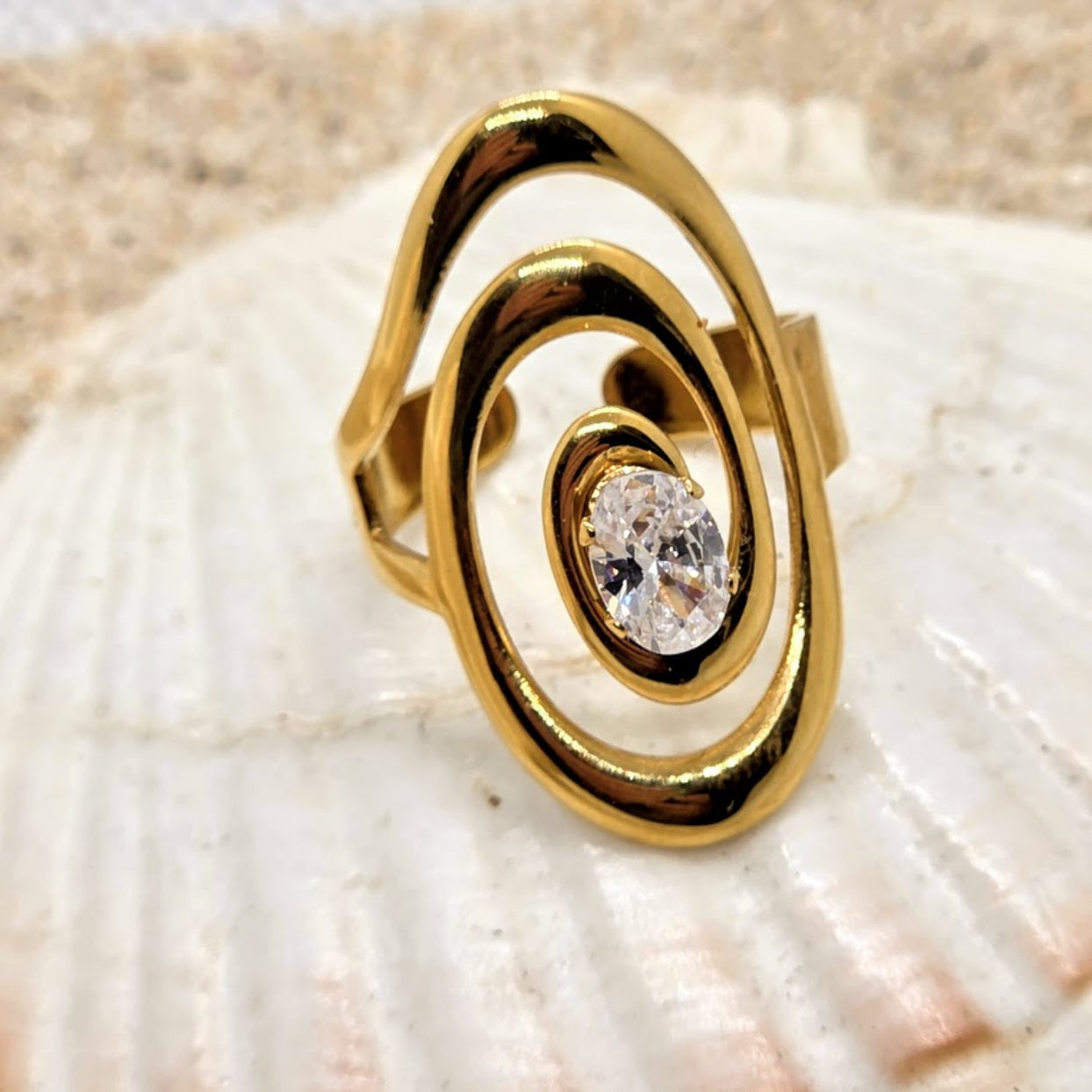 Gold ring with a diamond on a shell background