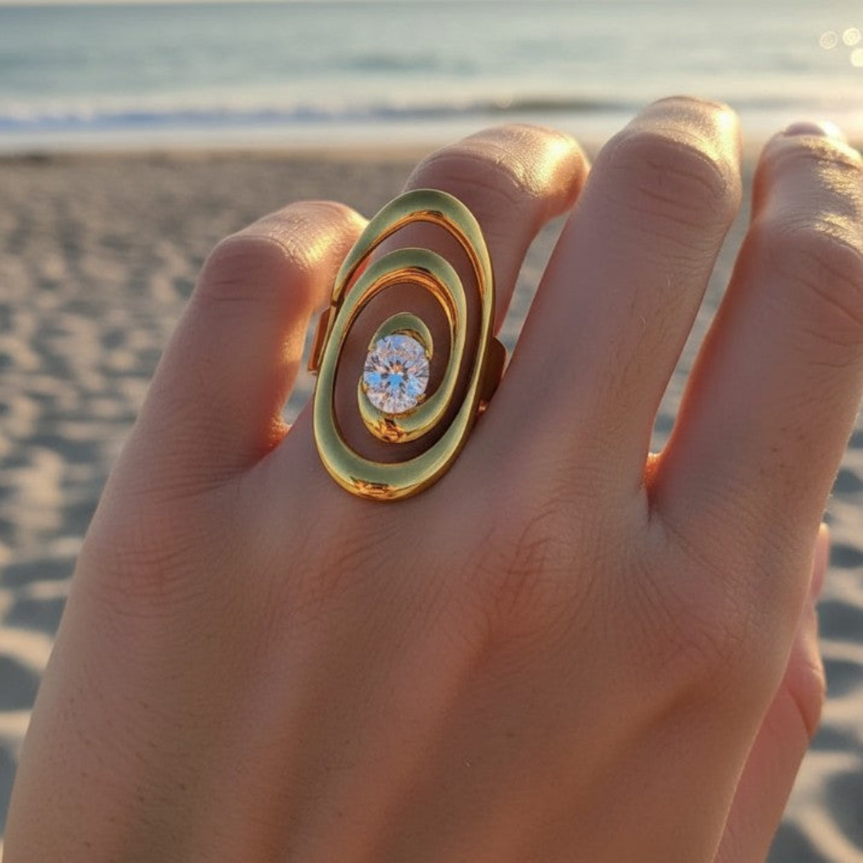 Gold ring with a diamond on a hand by the beach