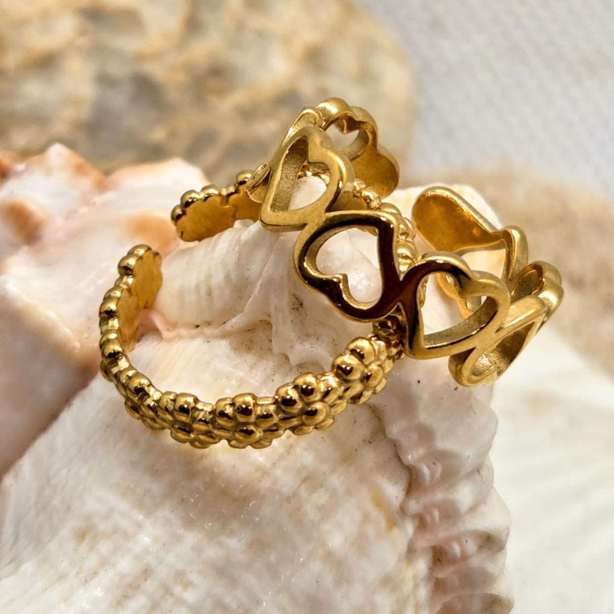 Gold ring with heart designs on a shell
