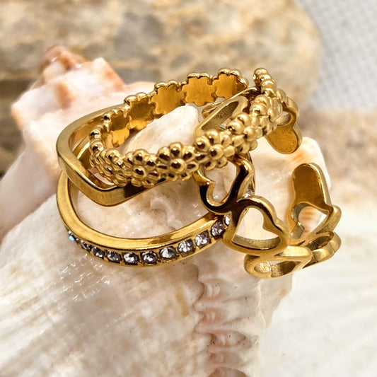 Gold ring with intricate design on a shell