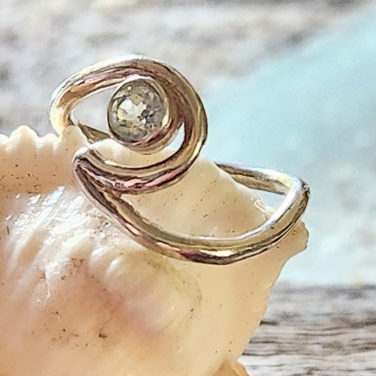 Gold ring with a diamond on a seashell
