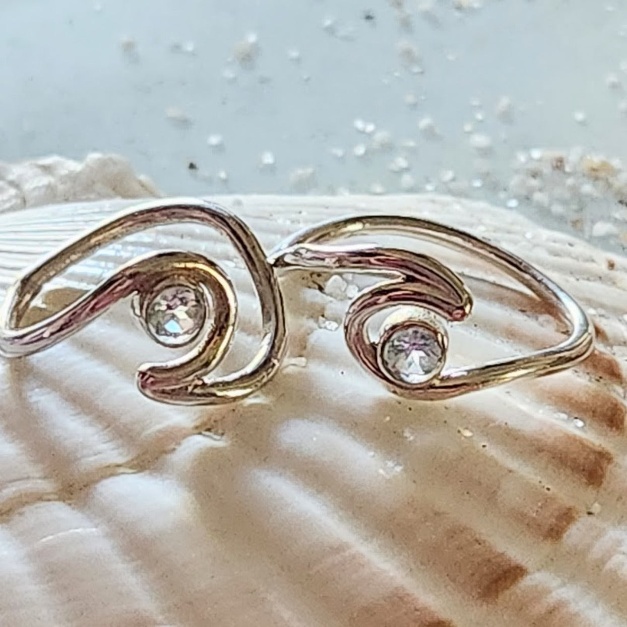 Gold ring with two diamonds on a seashell